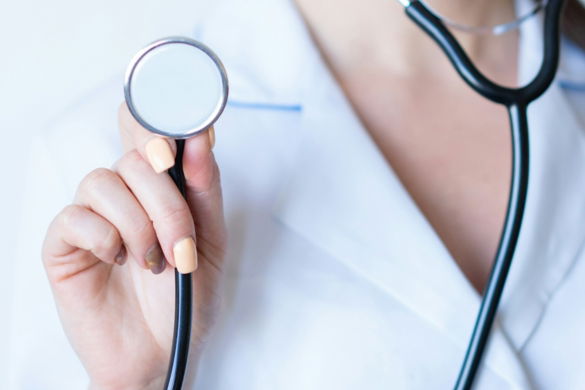 a-woman-in-a-white-shirt-holding-a-stethoscope.jpg a woman in a white shirt holding a stethoscope